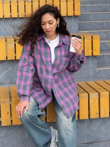 Detail of loose-fit plaid shirt with pink-blue check pattern and front pocket detail