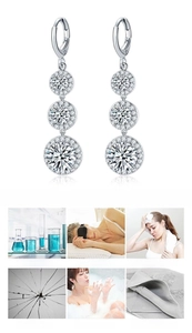 Detailed view of silver-tone teardrop zircon earrings with jewelry care instructions