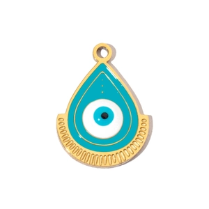 Macro shot of gold-plated evil eye charm with blue and white enamel detail
