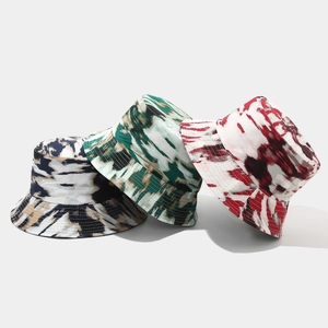 Detail view of tie-dye bucket hats in three colors with professional stitching rows