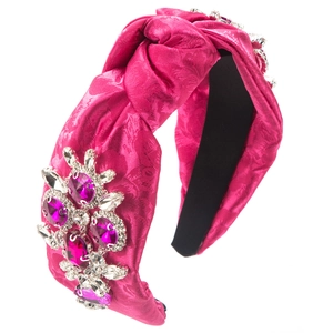 Detail of fuchsia jacquard headband featuring 3D floral rhinestone clusters and knot