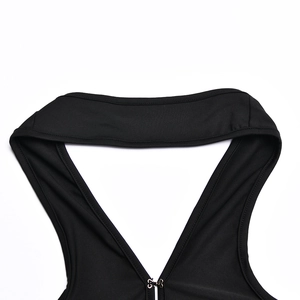 Detail of the plunging V-neckline with a metal hook closure on the black dress