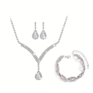 Detail view of silver bridal jewelry set with water drop rhinestones and wave patterns