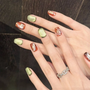 Handmade amber and matcha green press-on nails with gold foil and marble texture