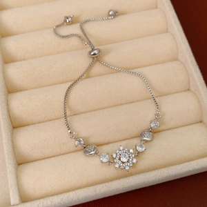 Detail of adjustable silver snowflake bracelet with sparkling cubic zirconia in jewelry box