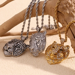 Detail of 18K gold and silver plated leopard head pendants with rhinestones on a branch
