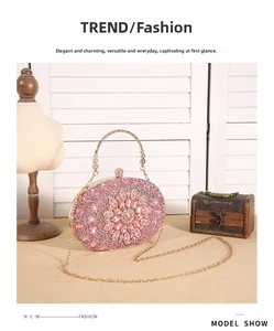 Detail of pink crystal flower evening clutch bag with round metal handle and gold chain