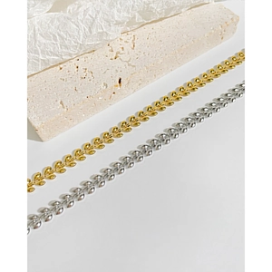 Close-up of elegant wheat leaf pattern chain bracelets in gold and silver finish