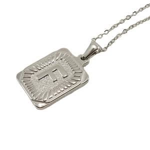 Silver stainless steel square pendant necklace featuring embossed letter F design