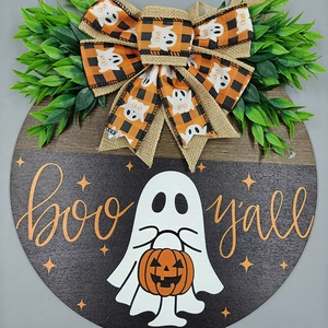 Detail of wooden Halloween door sign with white ghost, pumpkin, and boo y'all text