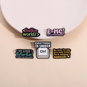 Set of 5 colorful enamel badges with geek and programmer themes in a top-down view