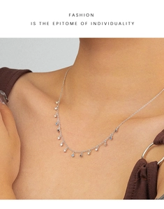 Detail of multi-color zircon pendant necklace on silver chain for elegant women