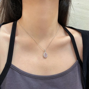 Close-up of S925 silver necklace with pink teardrop gemstone and zircon on collarbone