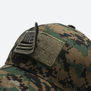 Detail showing the removable American flag embroidery patch on a digital camouflage cap