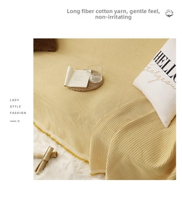 Close-up of mustard yellow waffle weave cotton sofa cover with soft breathable texture