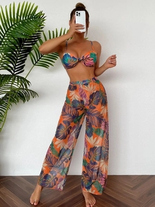 Detail of tropical leaf print mesh wide-leg pants and knot front bikini top set