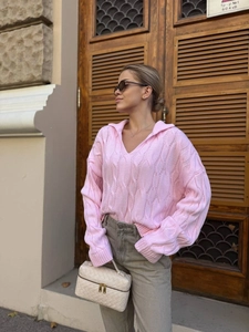 Casual pink knit sweater with cable pattern and V-neck collar for a relaxed style