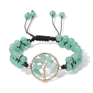 Detail of handmade Tree of Life charm with green natural stones and braided cord
