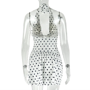 Rear view of white halter neck dress with black polka dots and elastic high waist