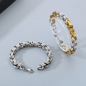 Detail of silver and gold-toned stainless steel Byzantine chain bracelet for men