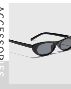 Close-up of minimalist black oval sunglasses with dark grey lenses in retro Y2K style