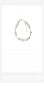 Detailed macro of S925 silver bracelet with freshwater pearls and shell cat charm
