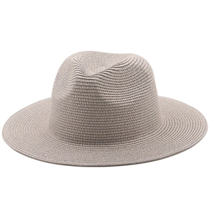 Close-up of lightweight brown straw fedora hat featuring fine woven texture and brim