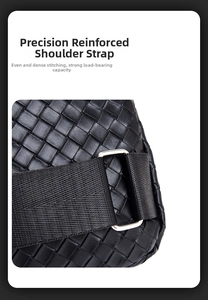 Detail of reinforced shoulder strap and precision stitching on black woven leather bag