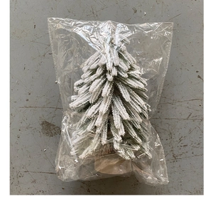 Miniature artificial Christmas tree with snow effect packaged in transparent plastic bag