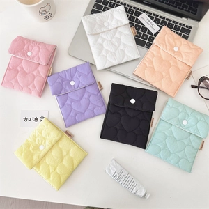 Detailed top view of quilted heart pattern storage pouches in seven vibrant colors