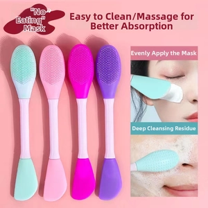 Close-up of double-headed silicone face mask brush with applicator and massage bristles
