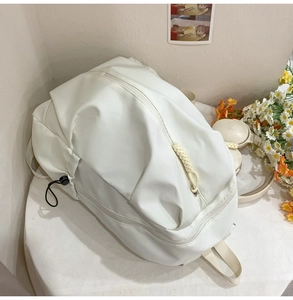 Detail shot of a minimalist large capacity white backpack for students and travel use
