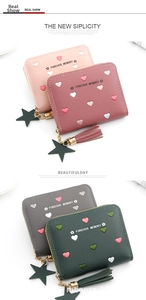 Close-up of heart embroidery, star pendant, and tassel on a PU leather mini wallet