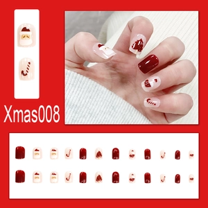 Detail of Christmas press-on nails featuring Santa, snowflakes, and festive patterns