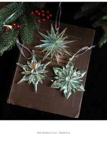 Detailed view of iridescent acrylic snowflake ornaments with large crystals on vintage books