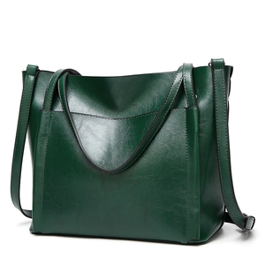 Minimalist oil wax leather tote bag in dark green featuring large capacity with slim straps