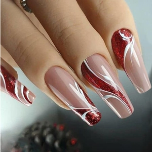 Macro detail of long coffin press-on nails with red glitter and white wave pattern