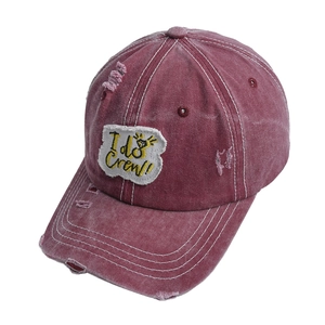 Detailed macro of distressed baseball cap with I do Crew embroidery and vintage torn effects