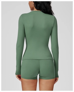 Back view of a green long-sleeved yoga top and matching shorts in professional sports fabric