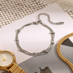 Three-layer silver beaded stainless steel bracelet with extension chain and lobster clasp