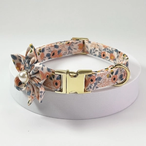 Detailed view of floral dog collar with gold metal buckle and pearl flower accent