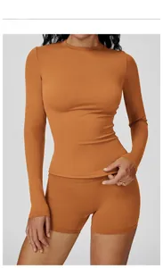 Detailed view of the Earl Orange long sleeve yoga top and high waist fitness shorts set