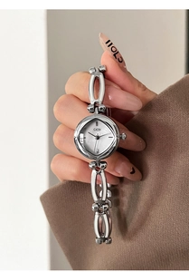 Close-up of elegant silver quartz bracelet watch with a mother-of-pearl dial for women
