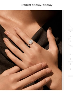Detailed view of emerald cut halo engagement ring with pavé diamonds on finger