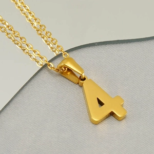 Detail view of gold-plated stainless steel number 4 pendant necklace with link chain