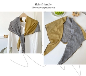 Detail of color-block cotton linen scarf with pleated texture and delicate beaded edges