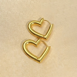 Minimalist 18k gold heart hoop earrings with polished geometric metal surface