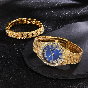 Detailed view of luxury gold-plated watch with blue dial and diamond-set Cuban bracelet