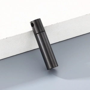 Detail of black cylindrical stainless steel pendant with brushed metal texture finish