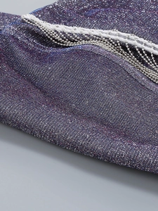 Detail of purple metallic fabric with silver bead chain tassels and white woven trim